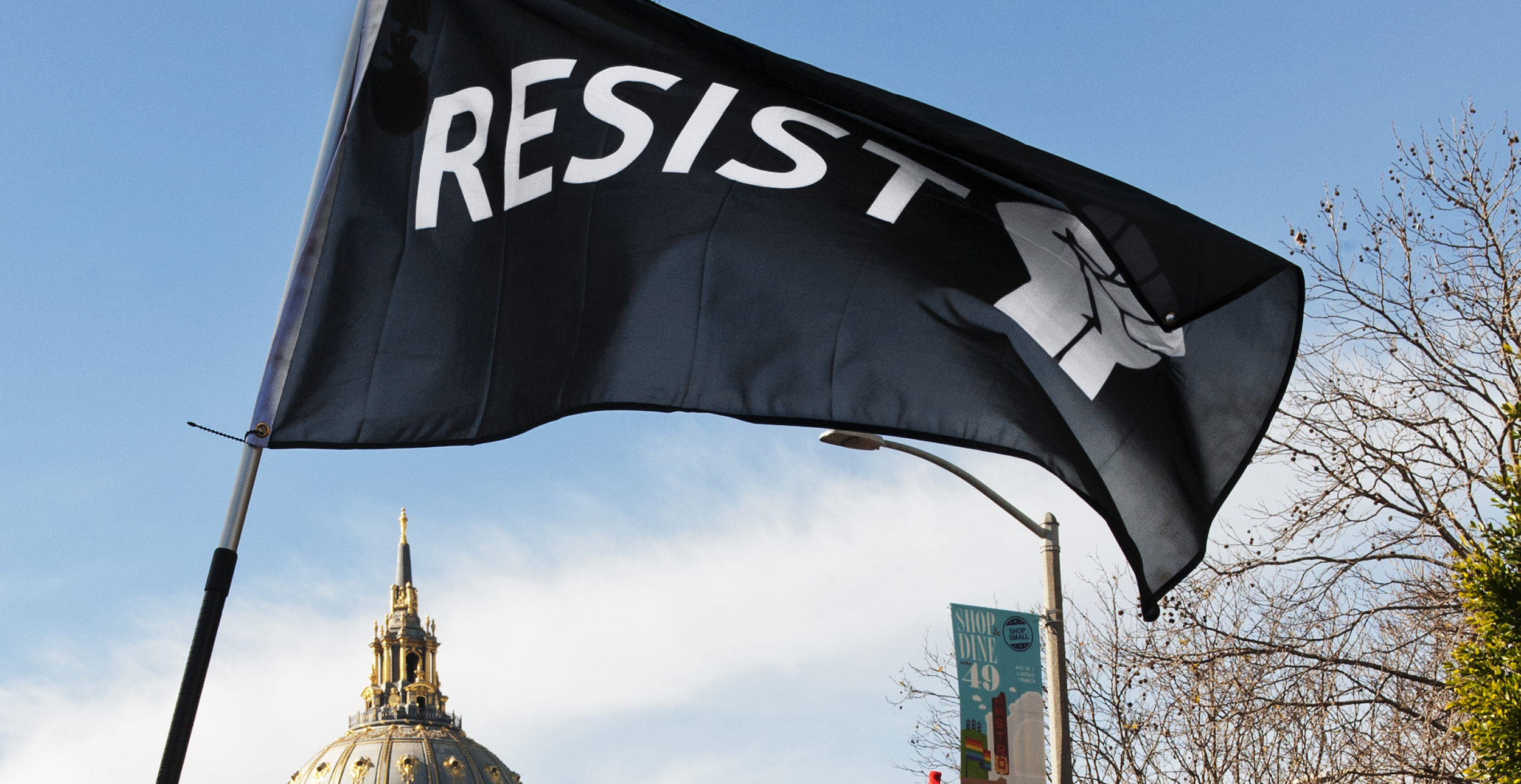 resist flag with SF City Hall building in the background