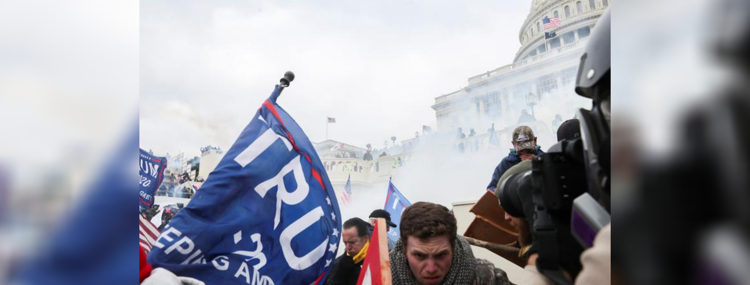 Protesters at Capitol, teargas and flags.